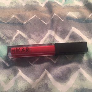 Hikari lip gloss in “salsa red”